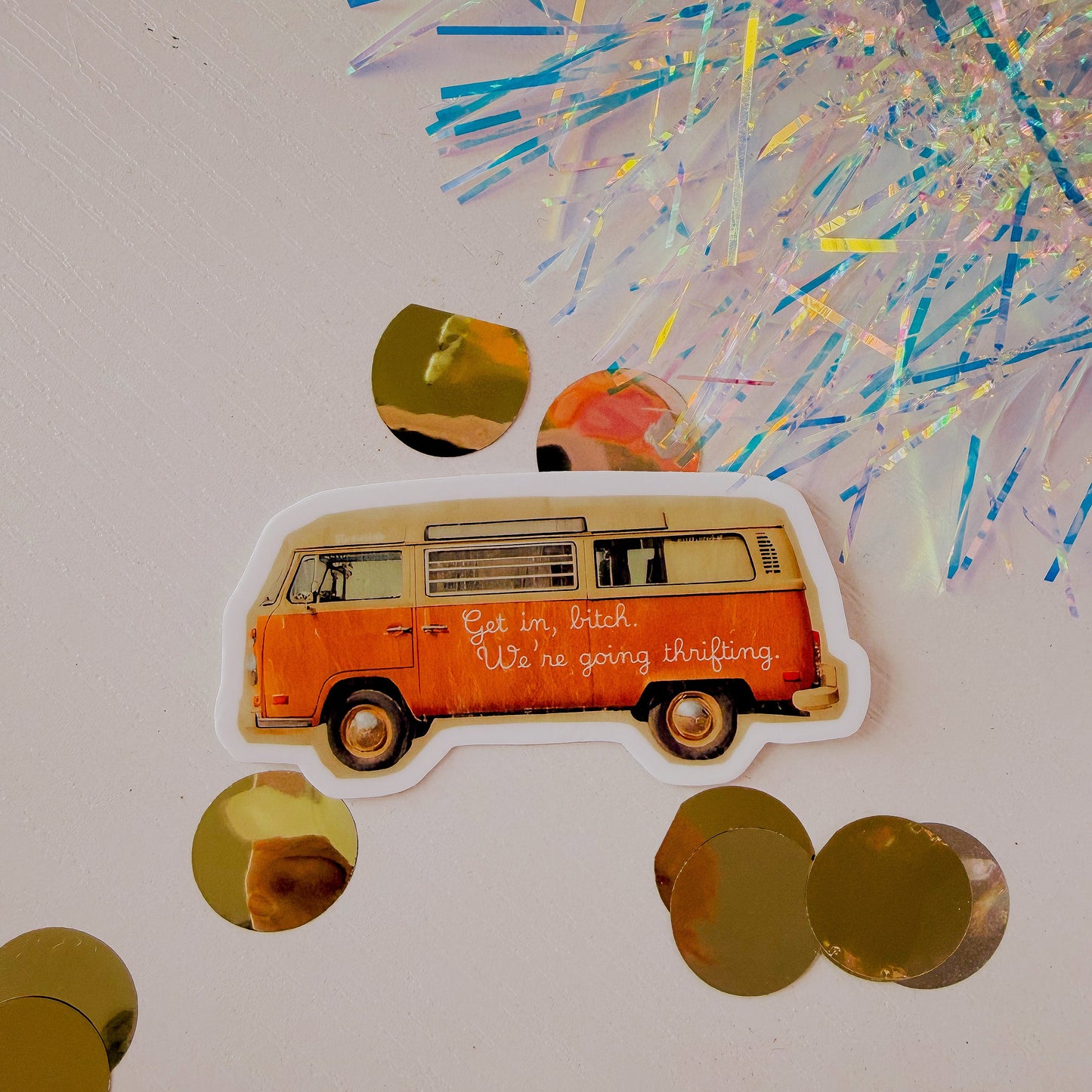 Sticker of a vintage van with text on a light gray background with confetti.
