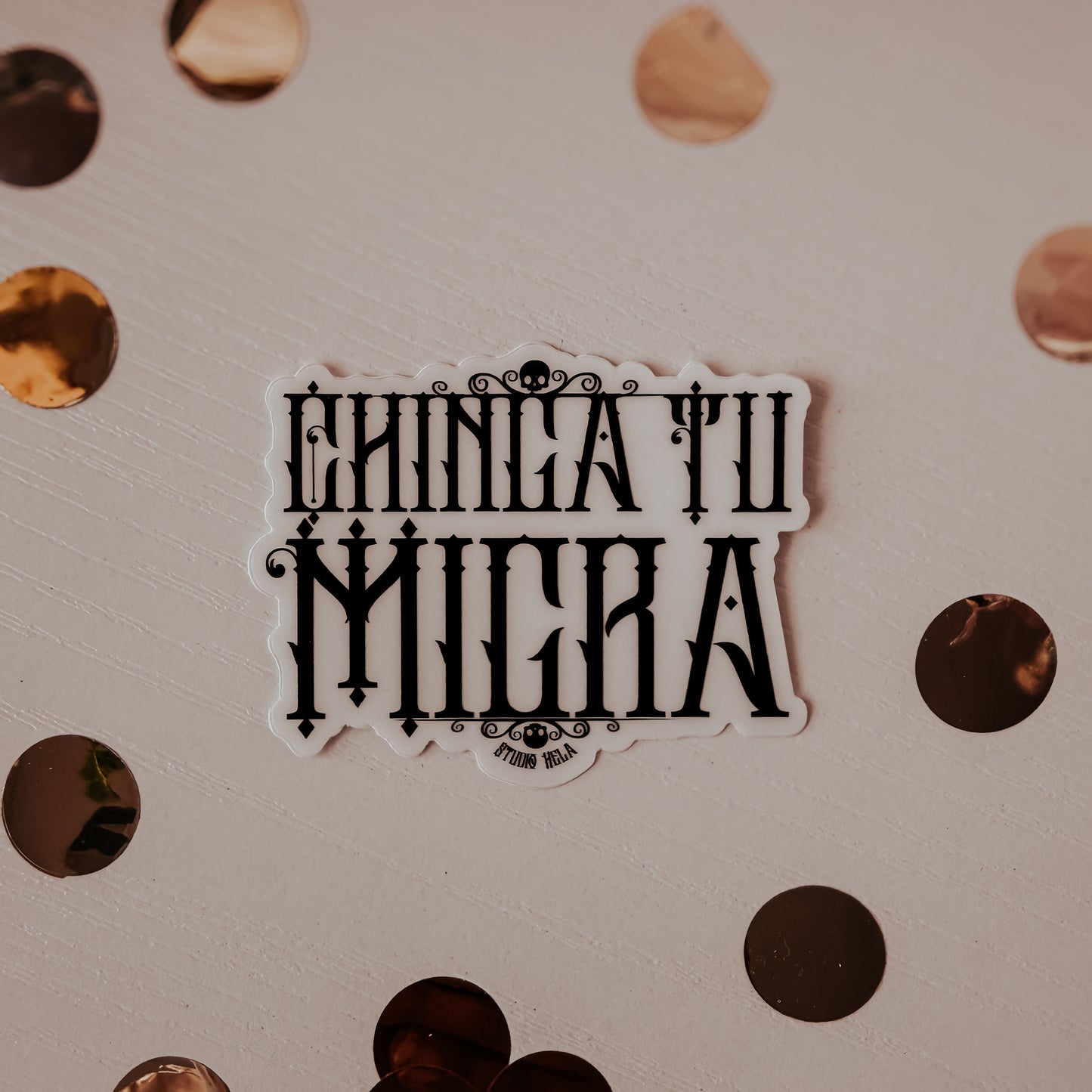 Sticker with 'Ehnicatii Milera' text on a textured surface with circular patterns.