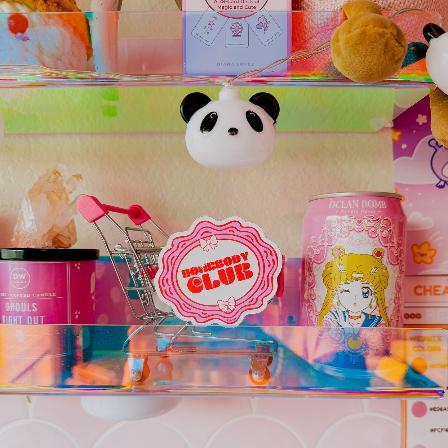Shelf with various items including a panda-shaped product, a 'Kawaii Club' sign, and a can with a character design.