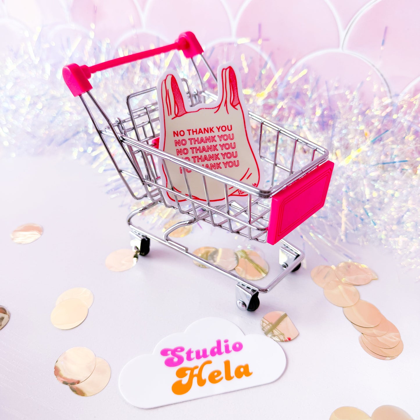 Small shopping cart with a dress and 'thank you' cards on a light background with confetti.
