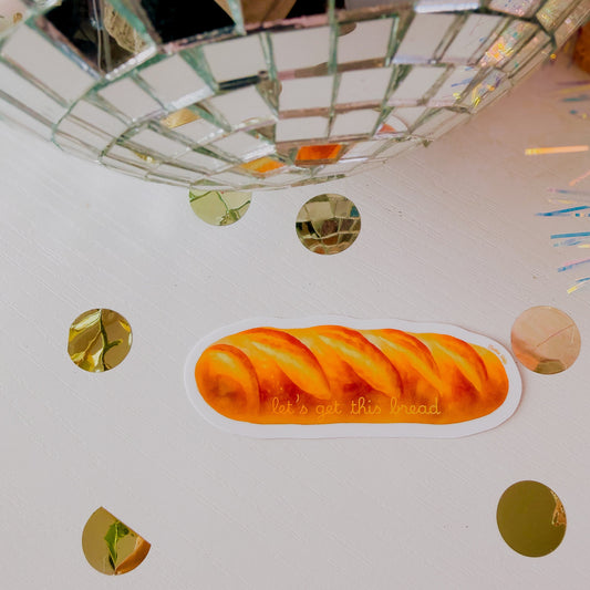 Sticker of a loaf of bread on a white surface with decorative elements