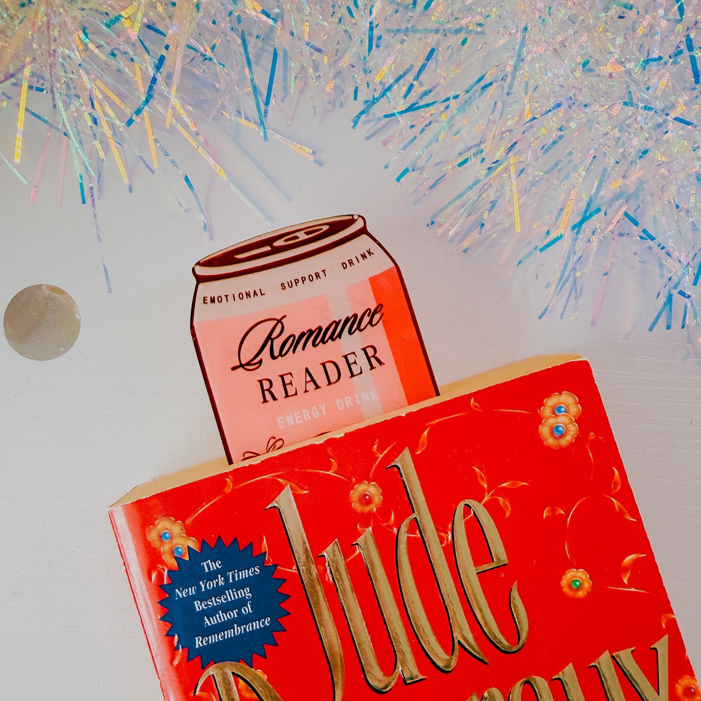 Book titled 'Lude Languid' with a can labeled 'Romance Reader' against a colorful abstract background.